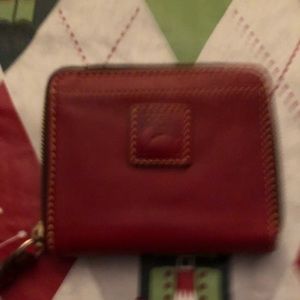 Dooney & Bourke red wallet. Barely used. Looks brand new. Includes paperwork.